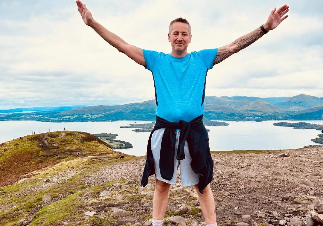 Jonny at top of a mountain